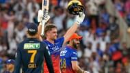 Jacks raises his bat after completing his century against the Titans.